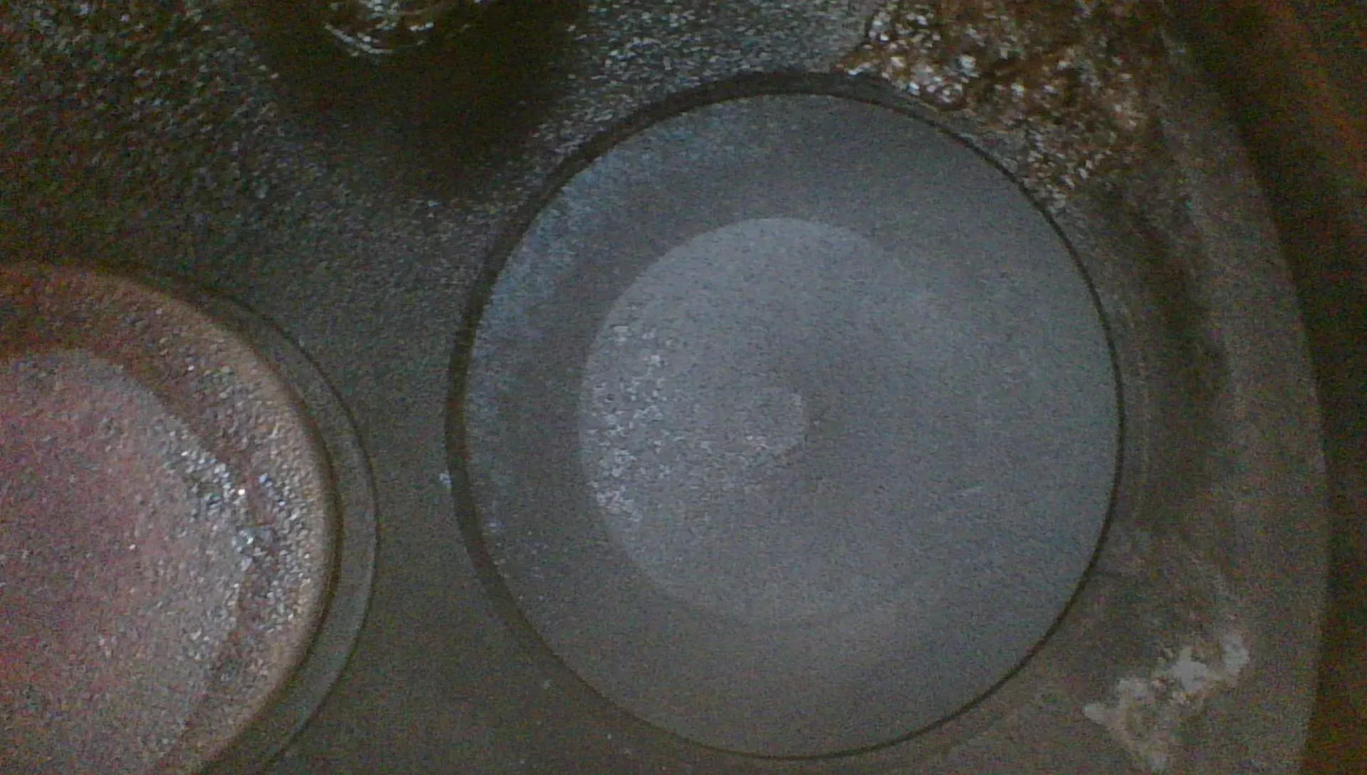 Borescope view of a clean intake valve head with even gray coloring and no combustion staining