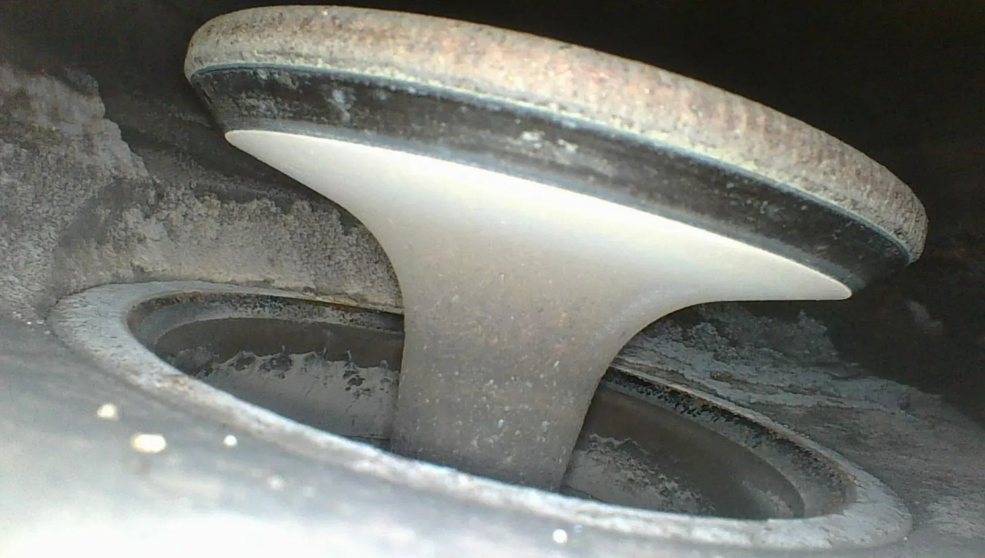 Borescope view of the intake valve held wide open, showing the valve face lifted off its seat