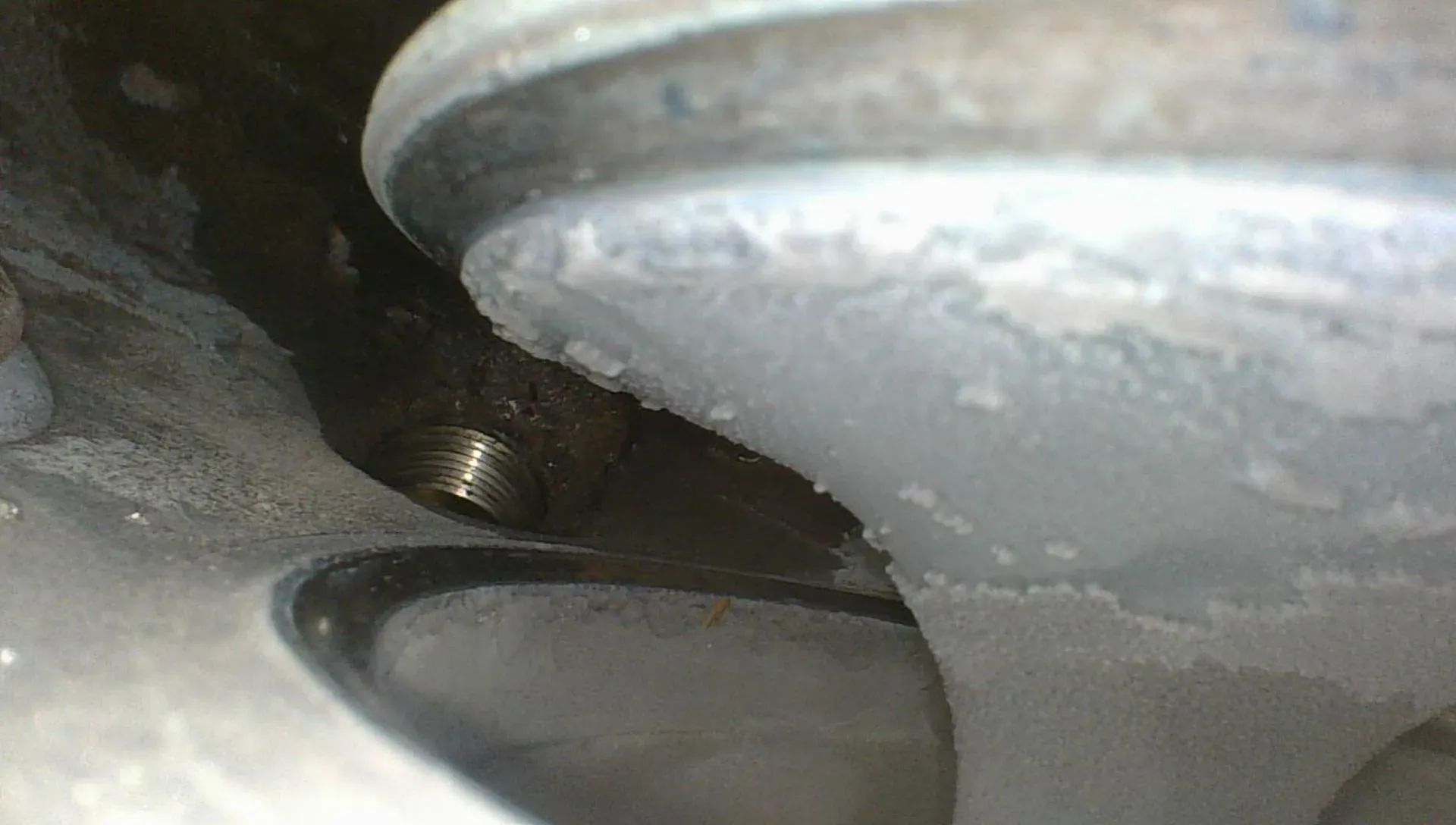 Borescope view of the exhaust valve seat wide open, showing the seat chamfer and contact ring