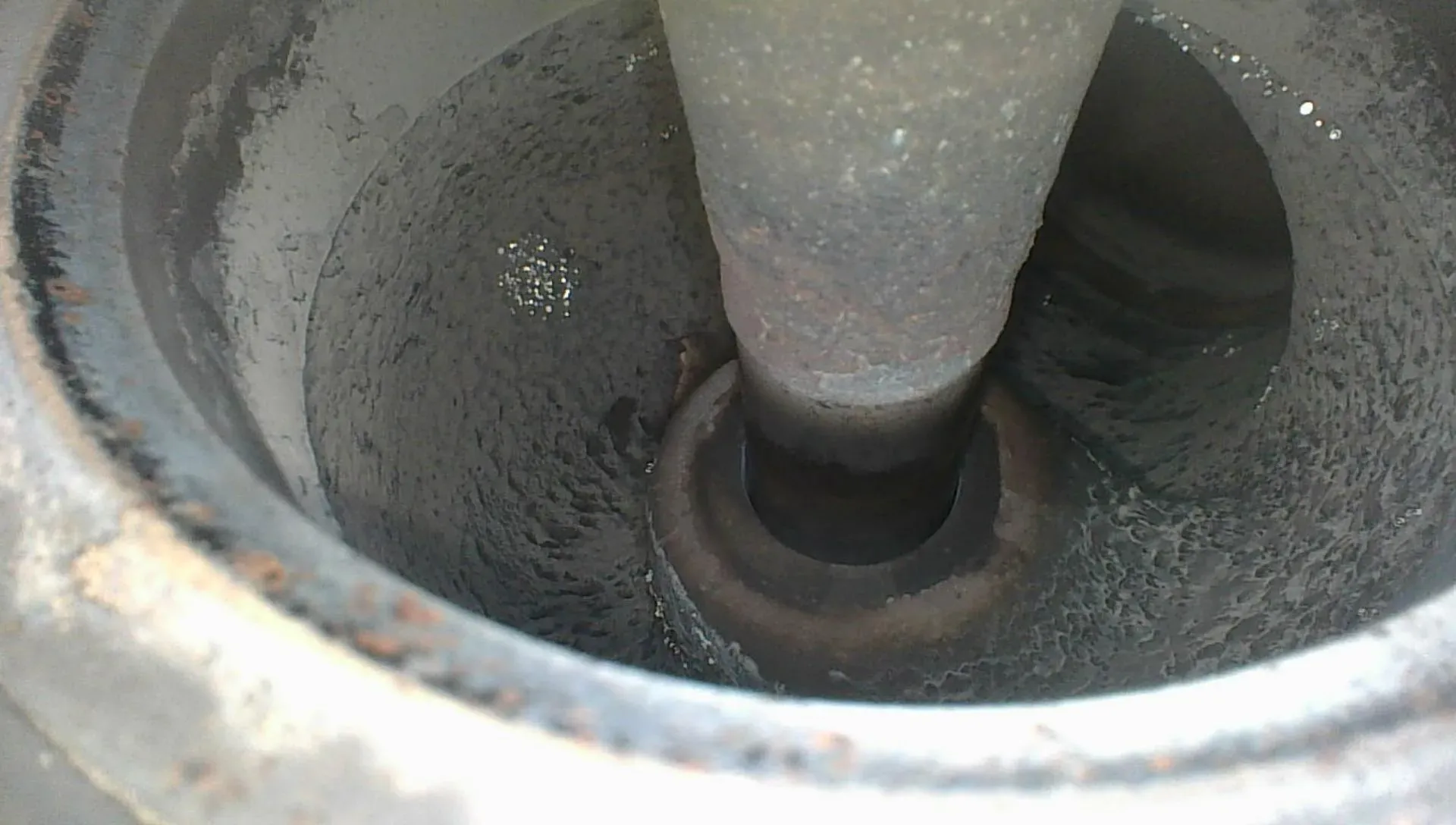 Borescope view down the exhaust valve stem toward the guide with the valve held open