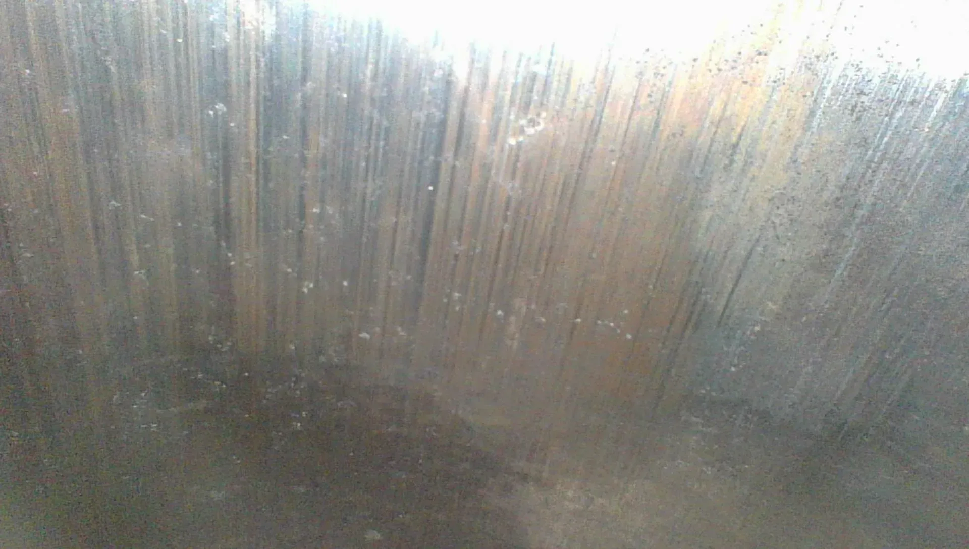 Borescope view of a cylinder wall quadrant with the honing cross-hatch still faintly visible