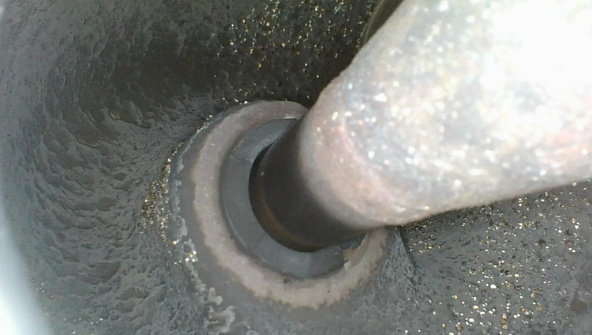 Borescope view up a valve stem showing heavy carbon buildup necking down around a deteriorating valve guide