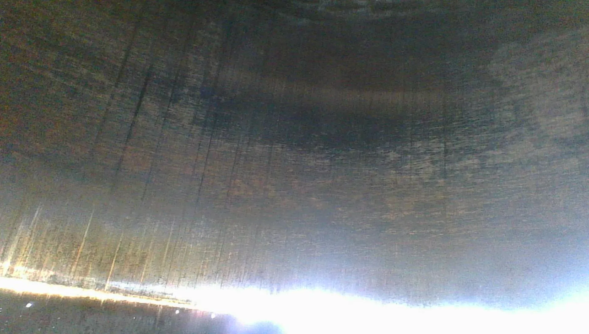 Borescope view of another cylinder wall showing a worn, mostly polished surface